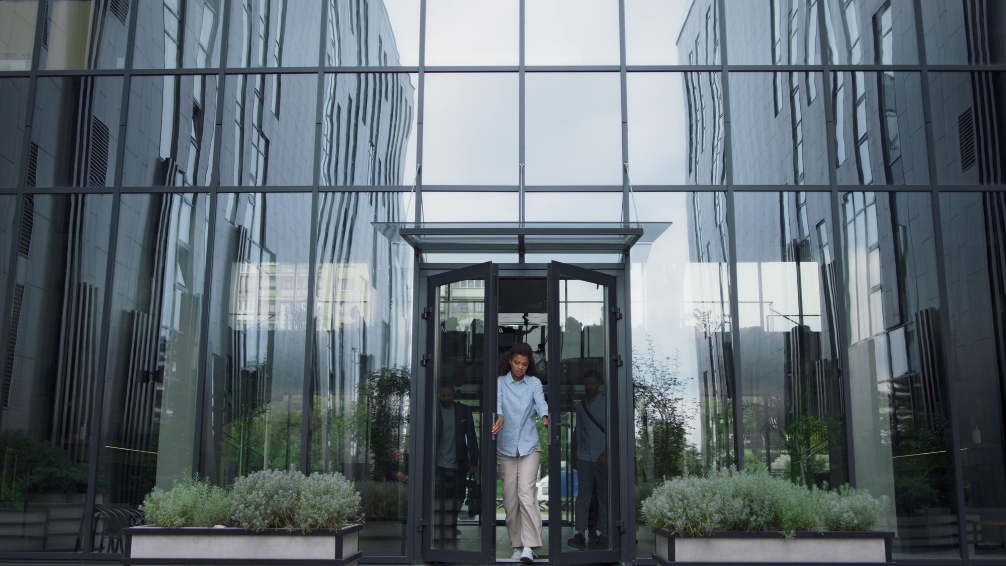 Upset manager standing at office door. Annoyed employees leaving shaming woman.