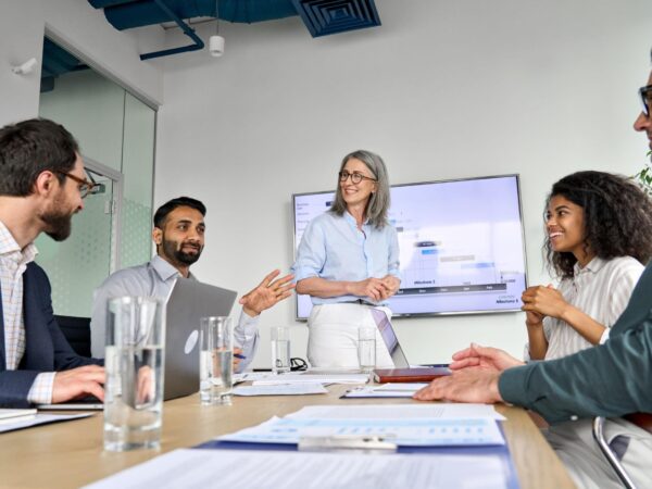 Diverse business leaders and professionals collaborating in a modern office meeting