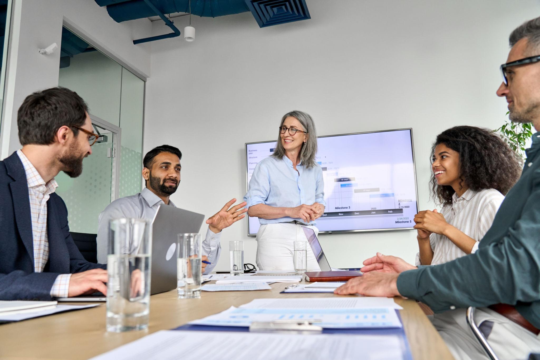 Diverse business leaders and professionals collaborating in a modern office meeting