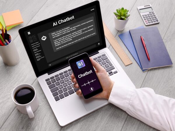 Professional employee using AI chatbot technology on a laptop in a modern office workspace